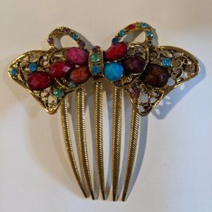 Hair comb with colorful gems. Gold comb